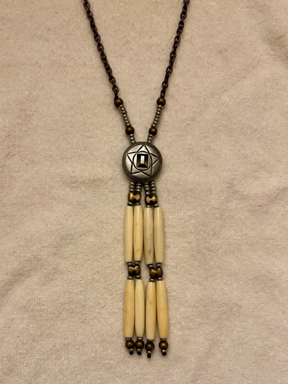 Vintage Native American-inspired necklace with metal medallion & hairpipe beads